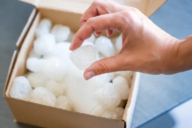 Eco packaging of parcels and white biodegradable filler. Box is filled with a filler safety for environment